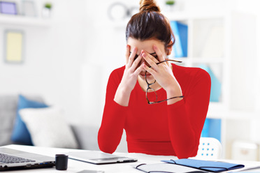 Discouraged business woman at desk