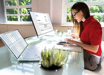 woman working at desk with invoices