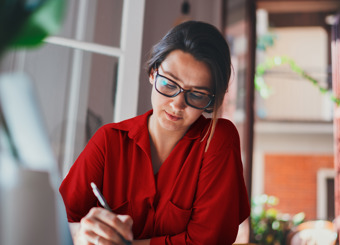 woman writing at her desk