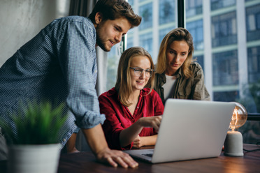 Young professionals looking at screen 