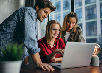 Young professionals looking at screen 