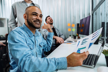 group of young business professional working in an office together