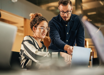 Coworkers Working Together by  laptop